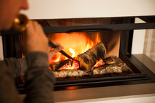 Ladda upp bild till gallerivisning, Picture of a man blowing in a Firedragon to revive a wood fire.