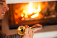 Image of man looking at the Firedragon's brass mouthpiece.