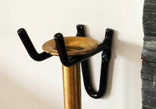 Load image into Gallery viewer, Image of a black bracket holding the brass mouthpiece of the Firedragon. It has the same design shape as the Firedragon prongs.
