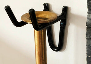 Picture of a black wall hanger holding a Firedragon with the brass mouthpiece.